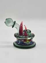 Freeekglass Atlantis dry hammer — transparent green body with red horns and patterned base, studio shot.
